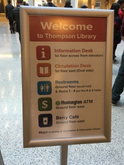 “Welcome sign for Thompson Library indicating what floors important features are on, such as, Info Desk, Restrooms, ATM, and Cafe”